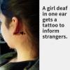 A girl def in one ear gets a tattoo to inform strangers